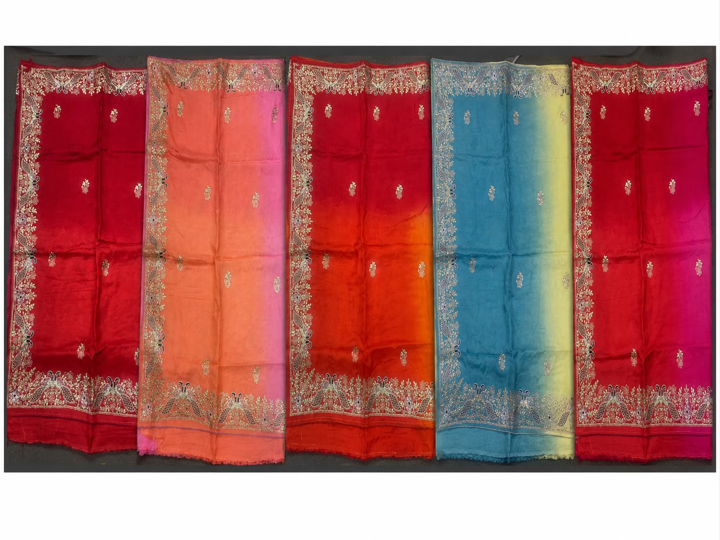 Colourful handcrafted sarees arranged side by side